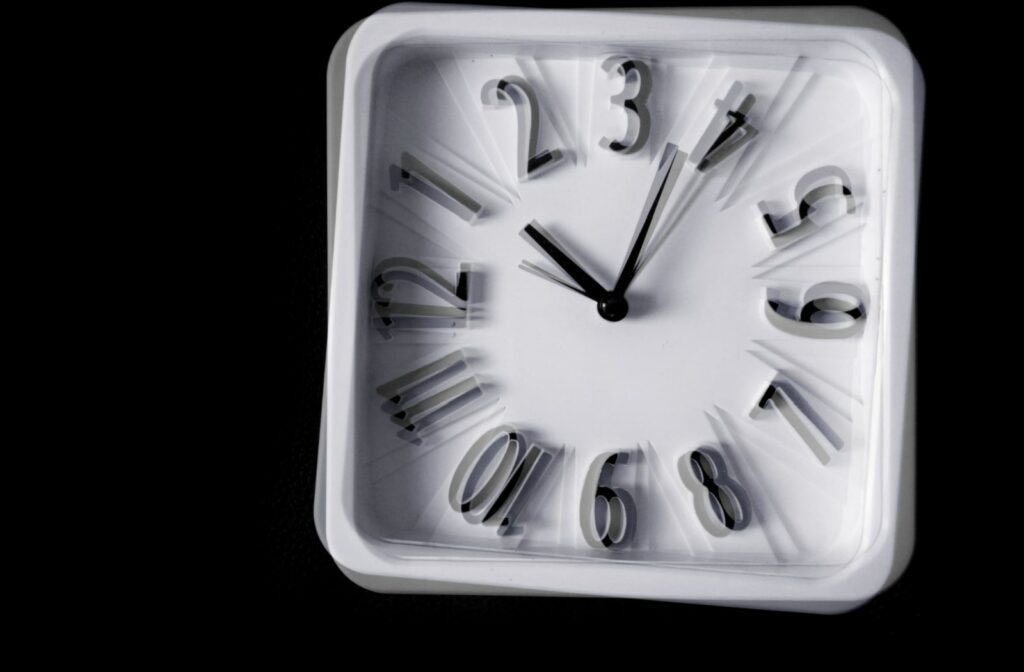 A blurred and distorted image of a wall clock. A sample vision of a person with astigmatism. a common eye problem that can make your vision blurry or distorted