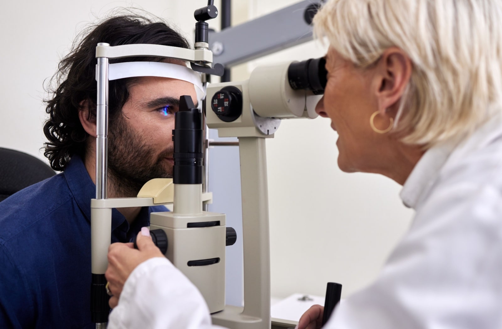 A man undergoing a slit lamp test as a part of his comprehensive eye exam.