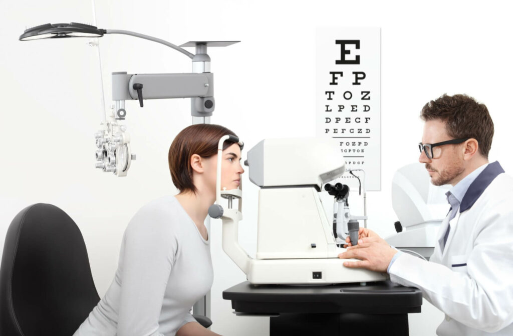 An optometrist uses a keratometer machine to measure their patient's eyes during a contact lens fitting appointment.